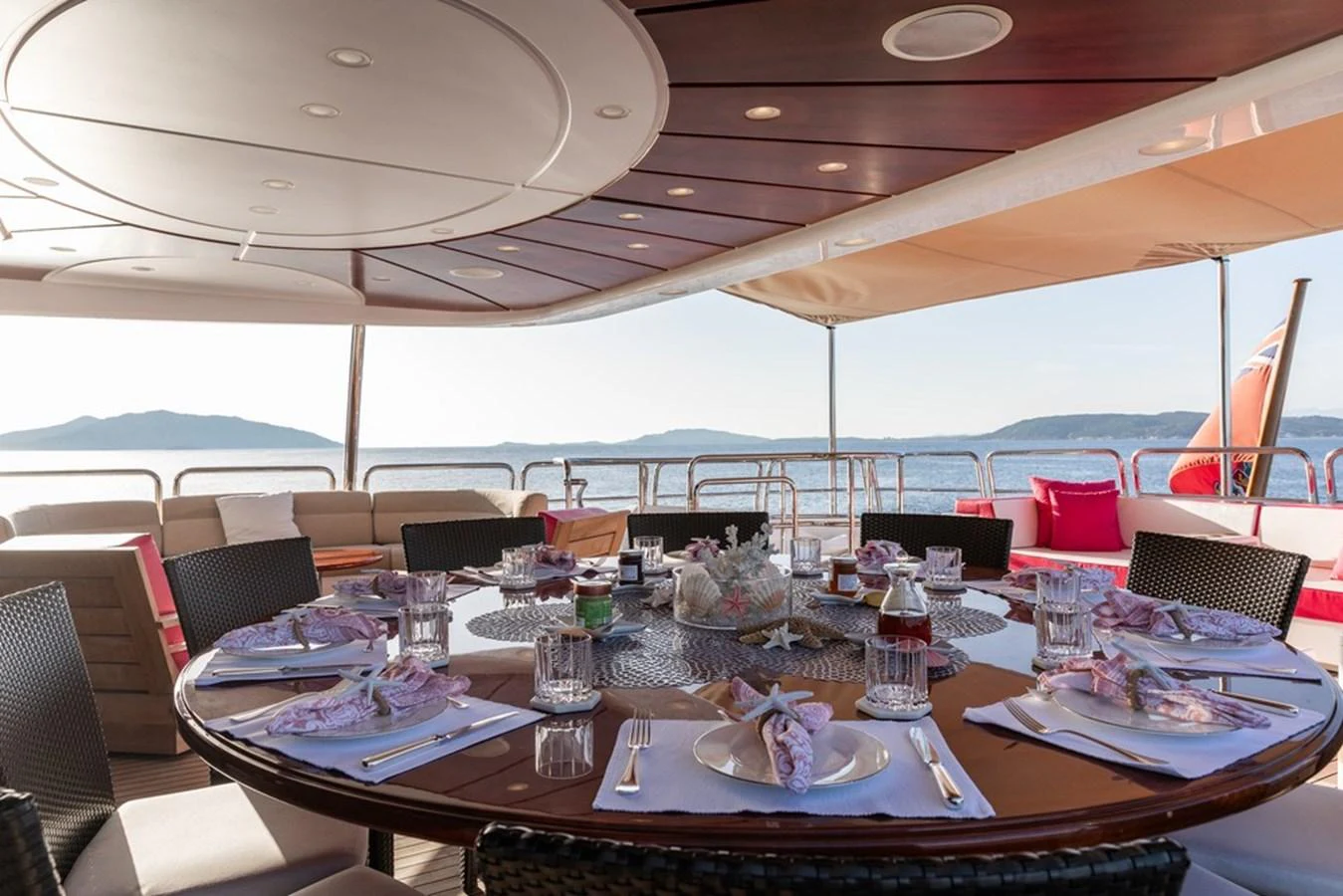 The aft deck features an elegant dining area with a stunning view of the sea. aboard VIRTUE Yacht for Sale