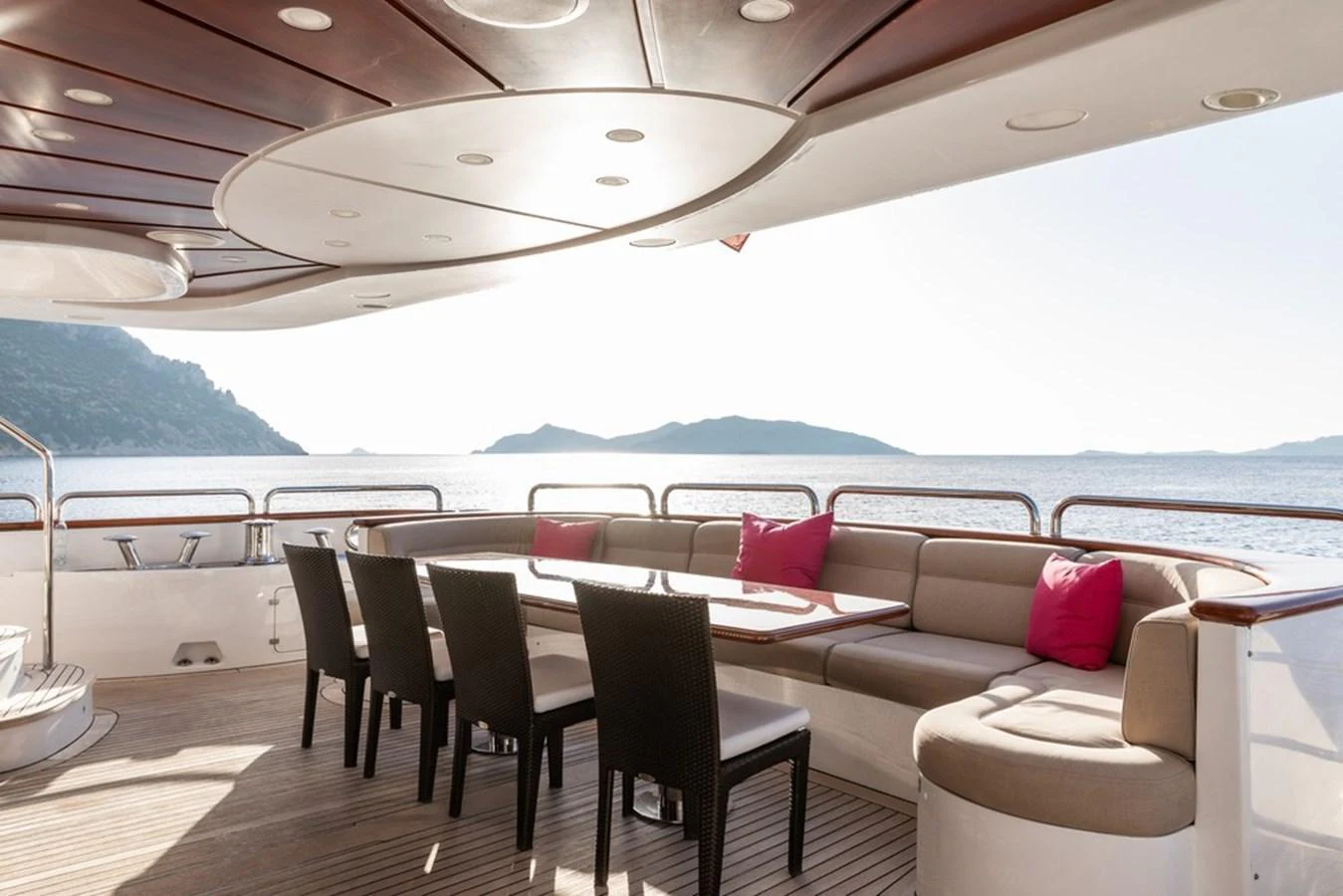 The aft deck features a spacious dining area with comfortable seating and stunning sea views. aboard VIRTUE Yacht for Sale