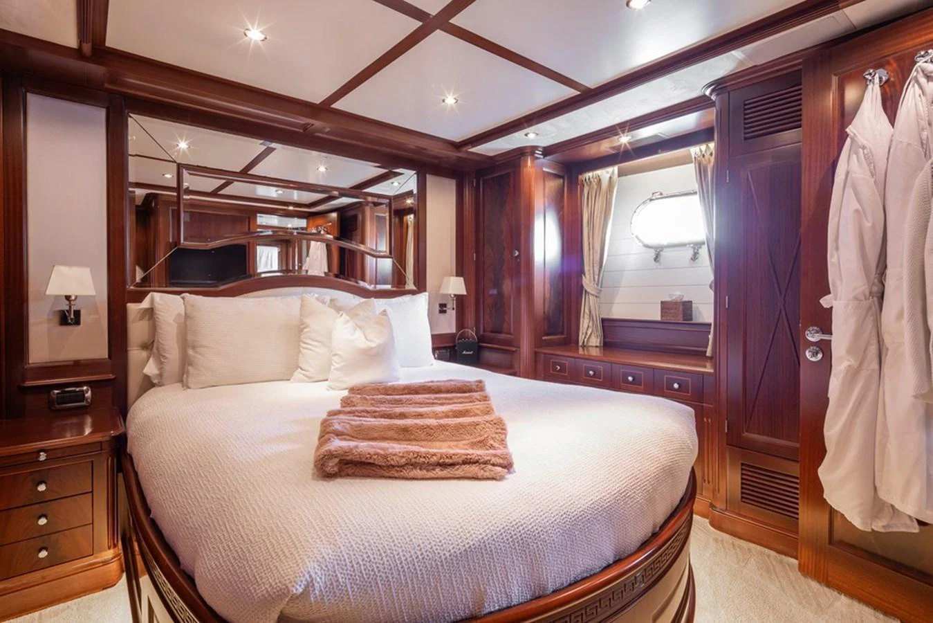 The master stateroom features luxurious wood paneling and plush bedding, creating an inviting and elegant retreat. aboard VIRTUE Yacht for Sale
