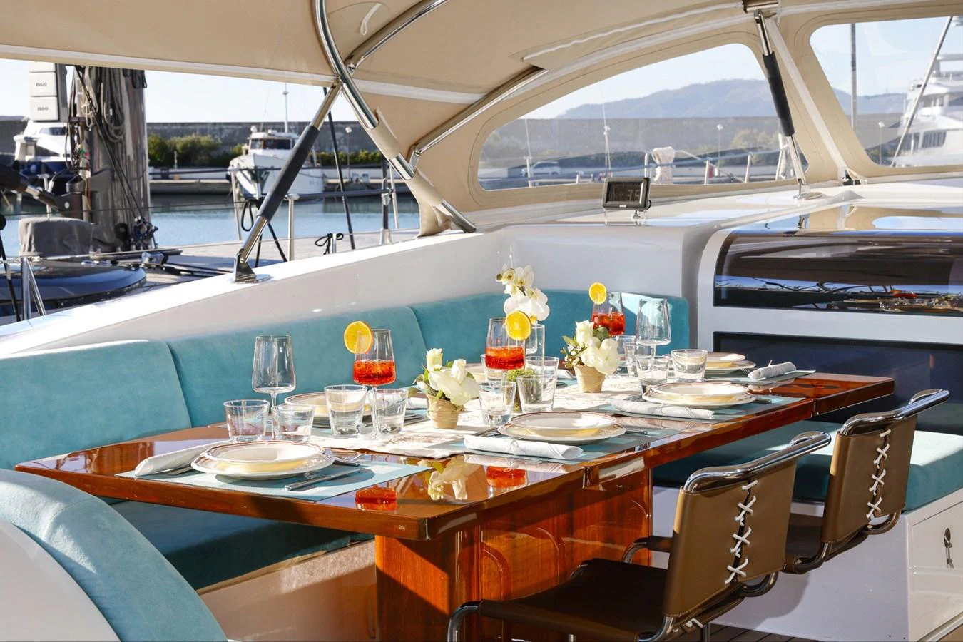 a table with glasses and plates on it aboard CAPRICORNO Yacht for Sale