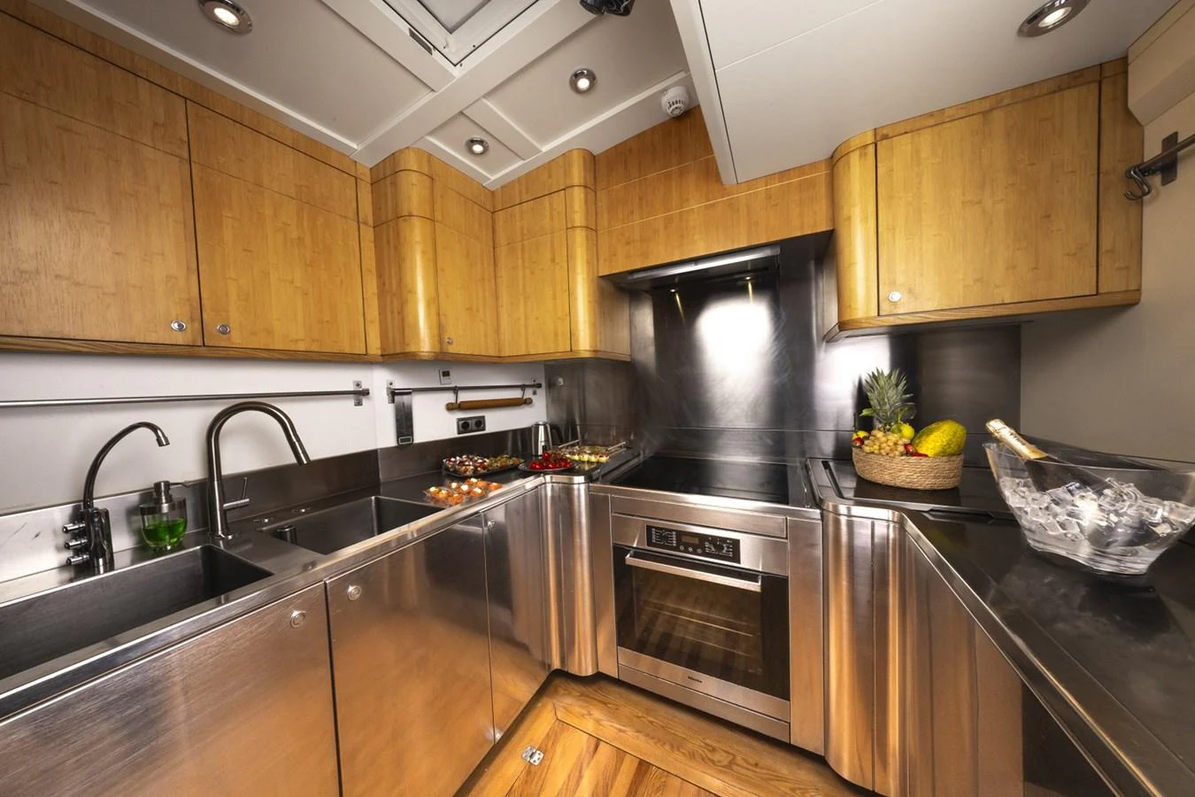 a kitchen with wooden cabinets aboard CAPRICORNO Yacht for Sale