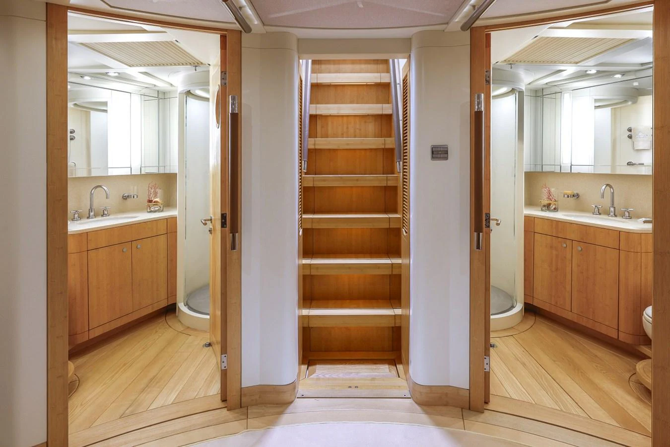 a bathroom with a wood door aboard CAPRICORNO Yacht for Sale