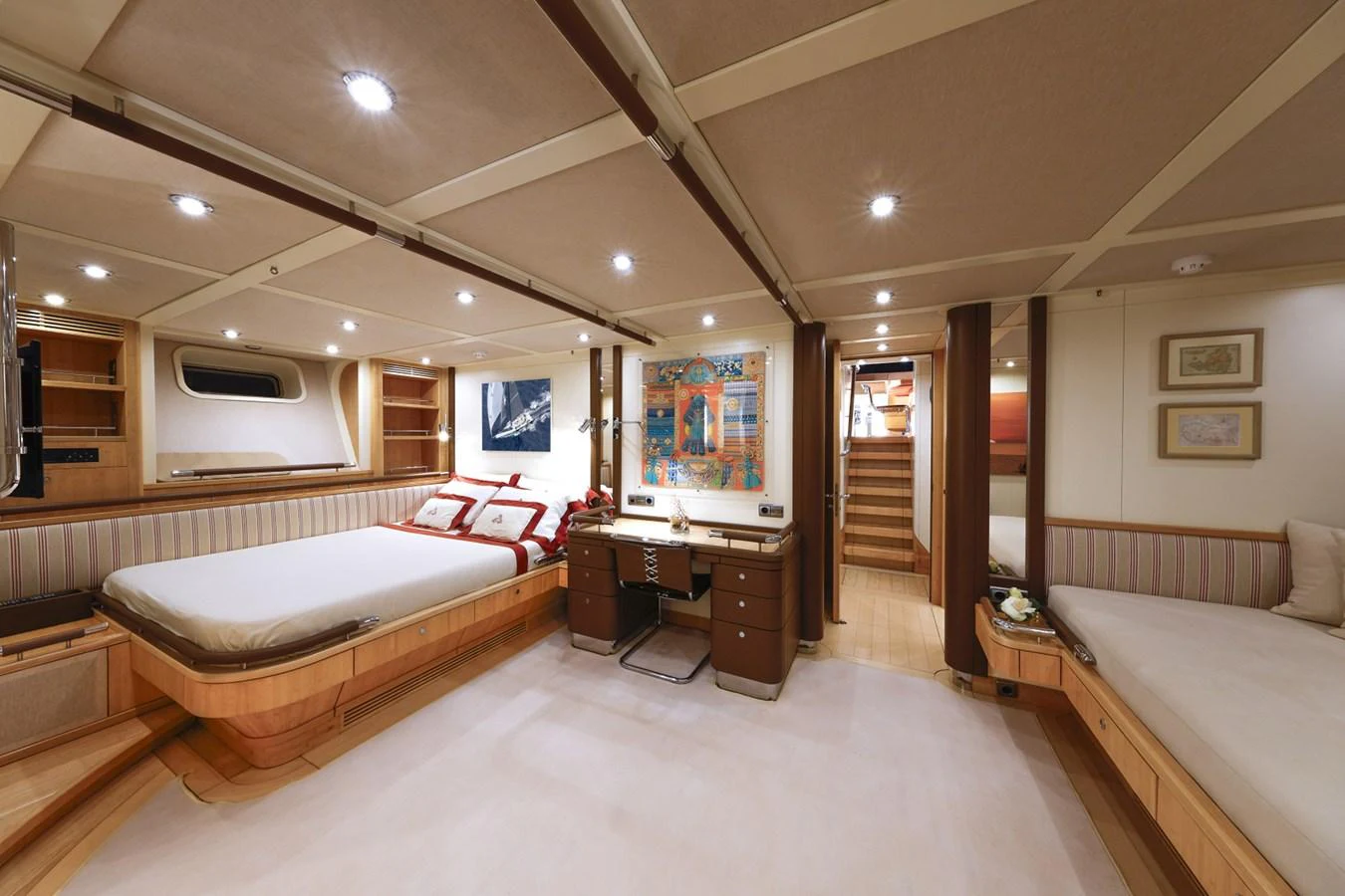 a large room with a bed and a desk aboard CAPRICORNO Yacht for Sale