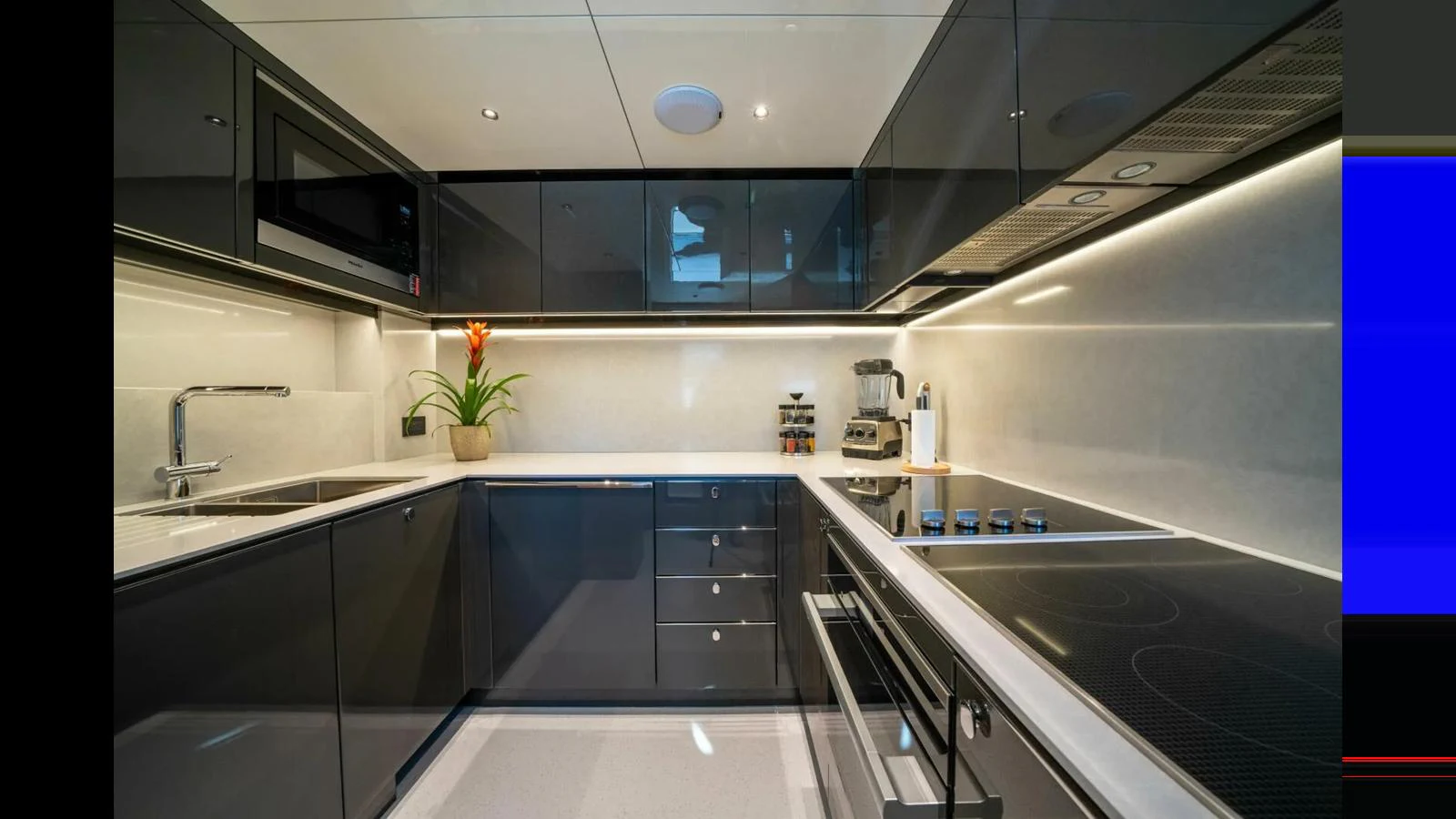 a kitchen with black cabinets aboard 100 YACHT Yacht for Sale
