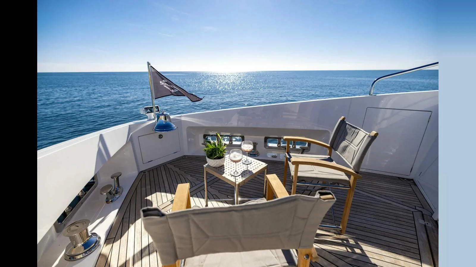a deck with a table chairs and a view of the ocean aboard 100 YACHT Yacht for Sale