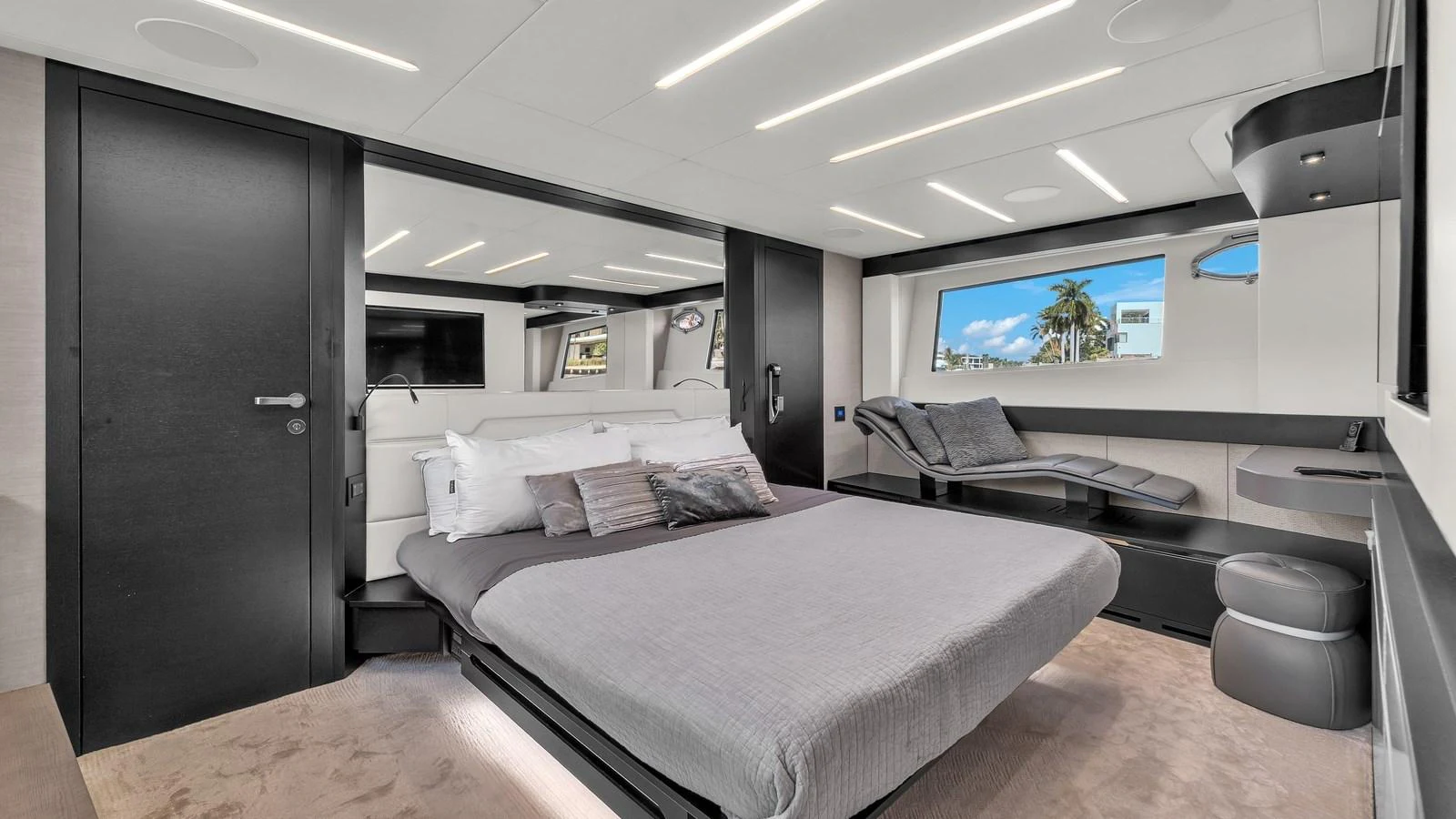 a room with a bed and desk aboard ALEXANDRA Yacht for Sale