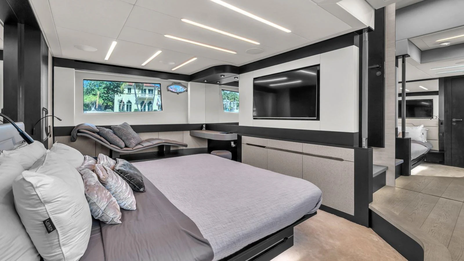 a bedroom with a bed and a tv aboard ALEXANDRA Yacht for Sale
