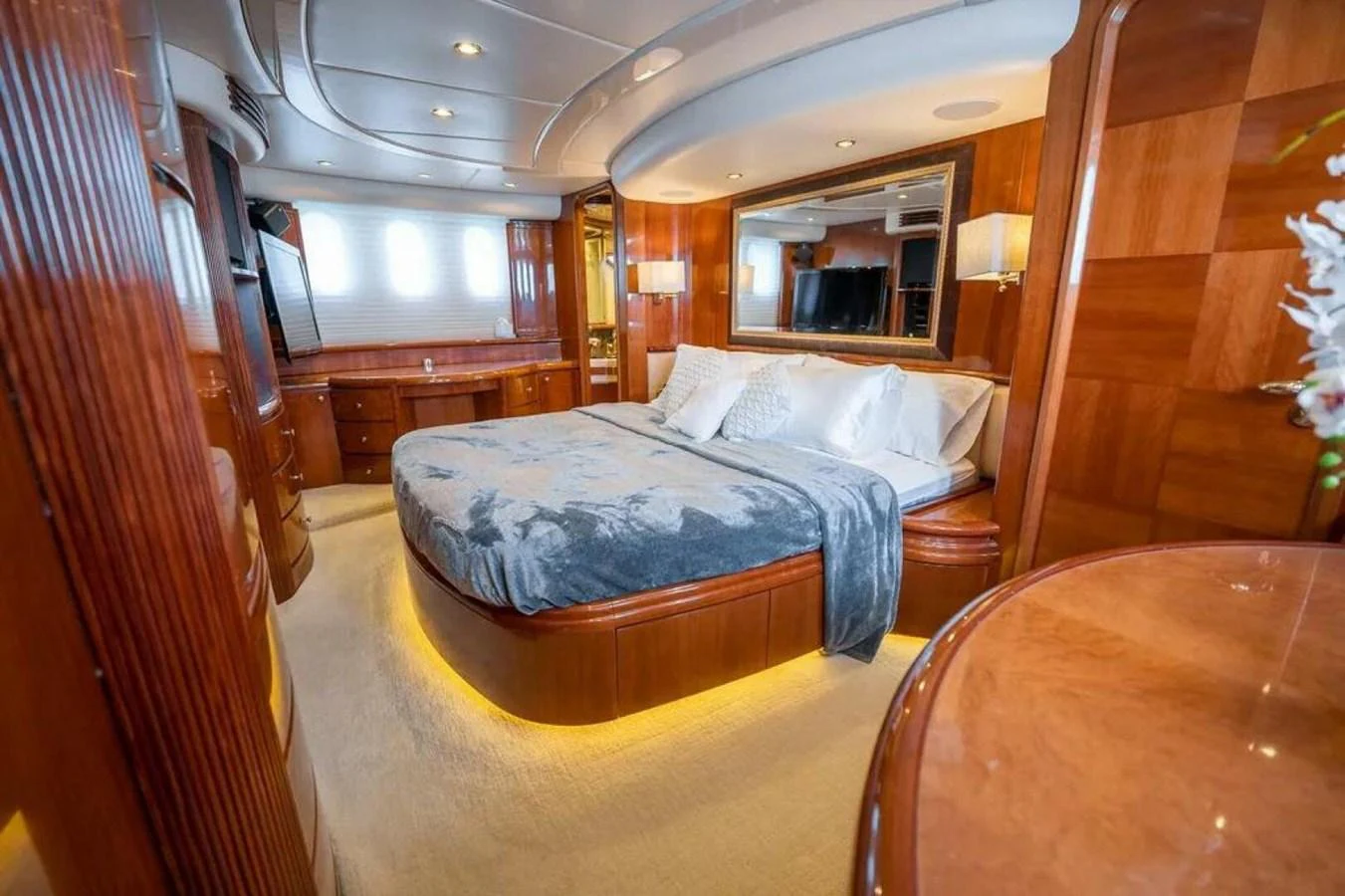 a bedroom with a bed and a table aboard AZURE Yacht for Sale