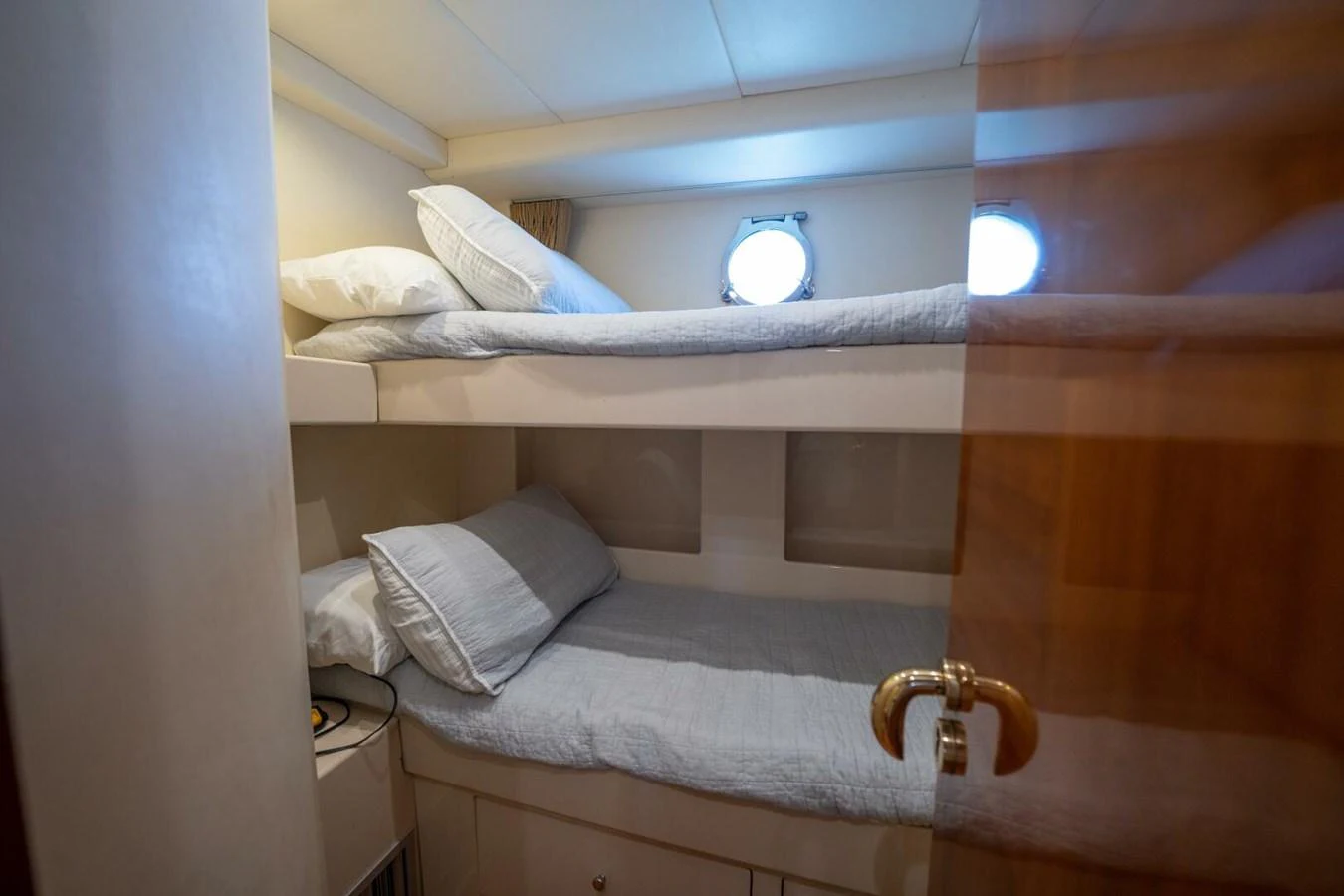a bed with a light on the wall aboard AZURE Yacht for Sale