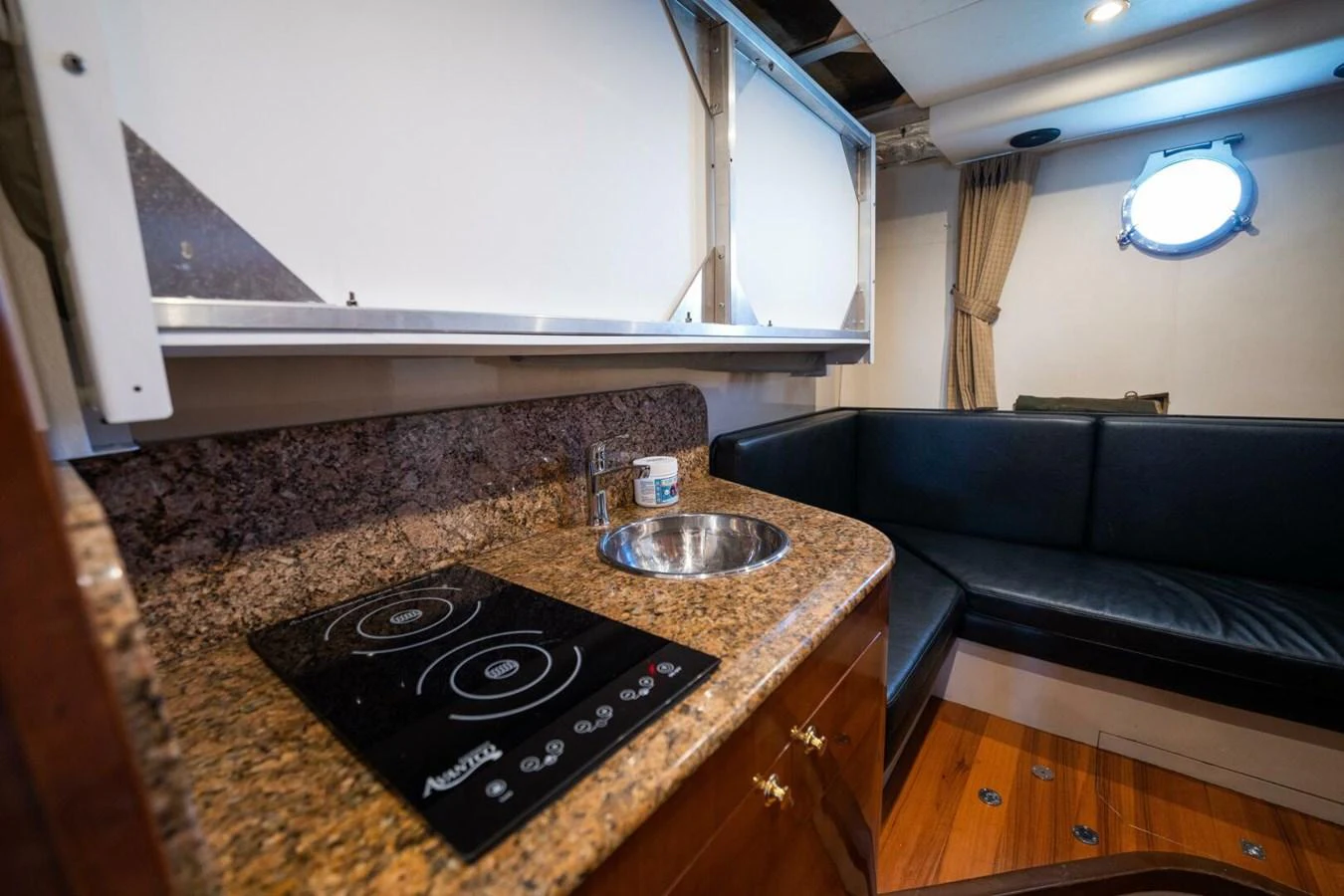 a kitchen with a black stove aboard AZURE Yacht for Sale
