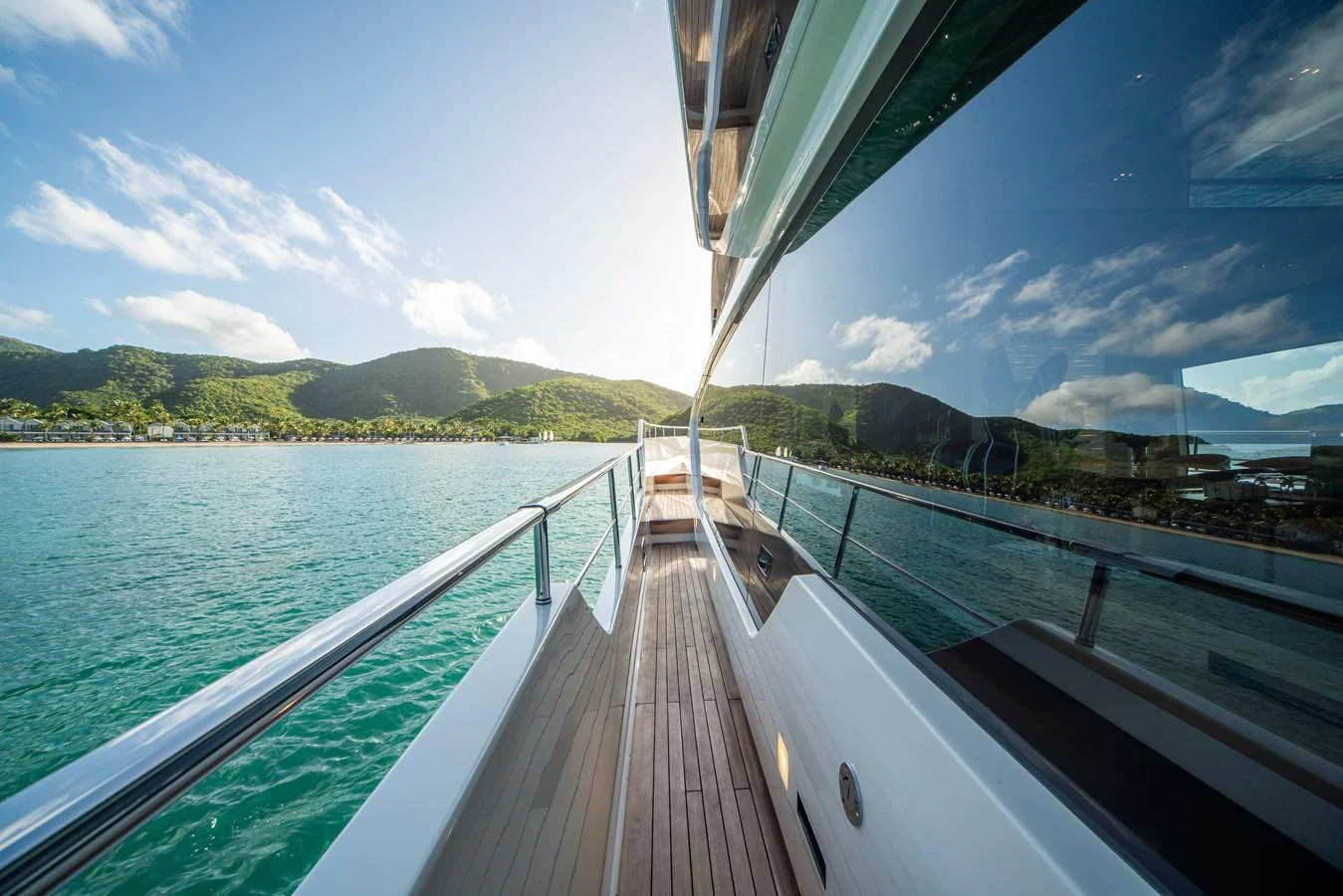 A sleek side deck with stunning views of the surrounding water and landscape. aboard AKULA Yacht for Sale