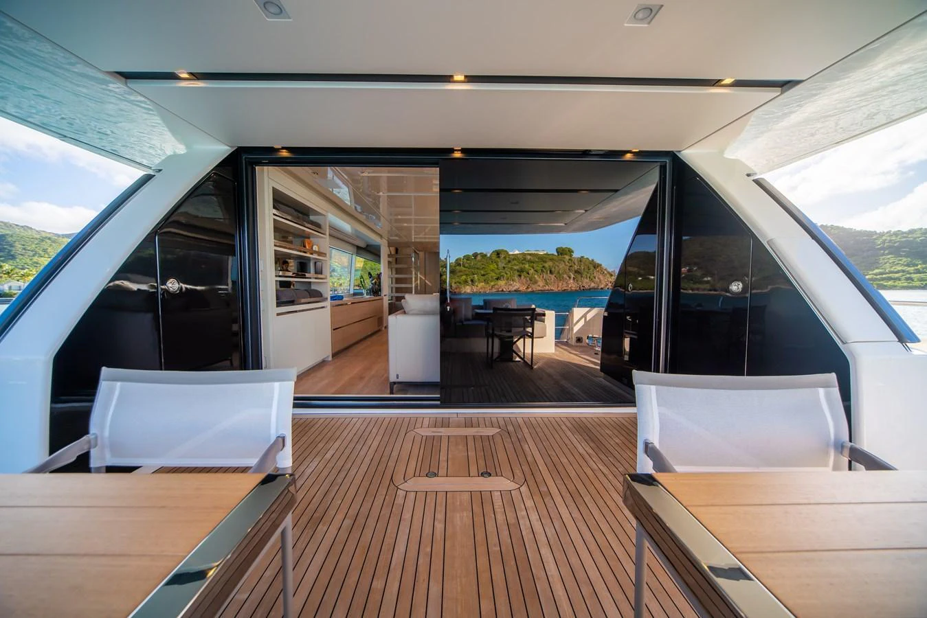 The aft deck offers a seamless transition from the outdoor seating area to the luxurious interior, with stunning views of the surrounding landscape. aboard AKULA Yacht for Sale
