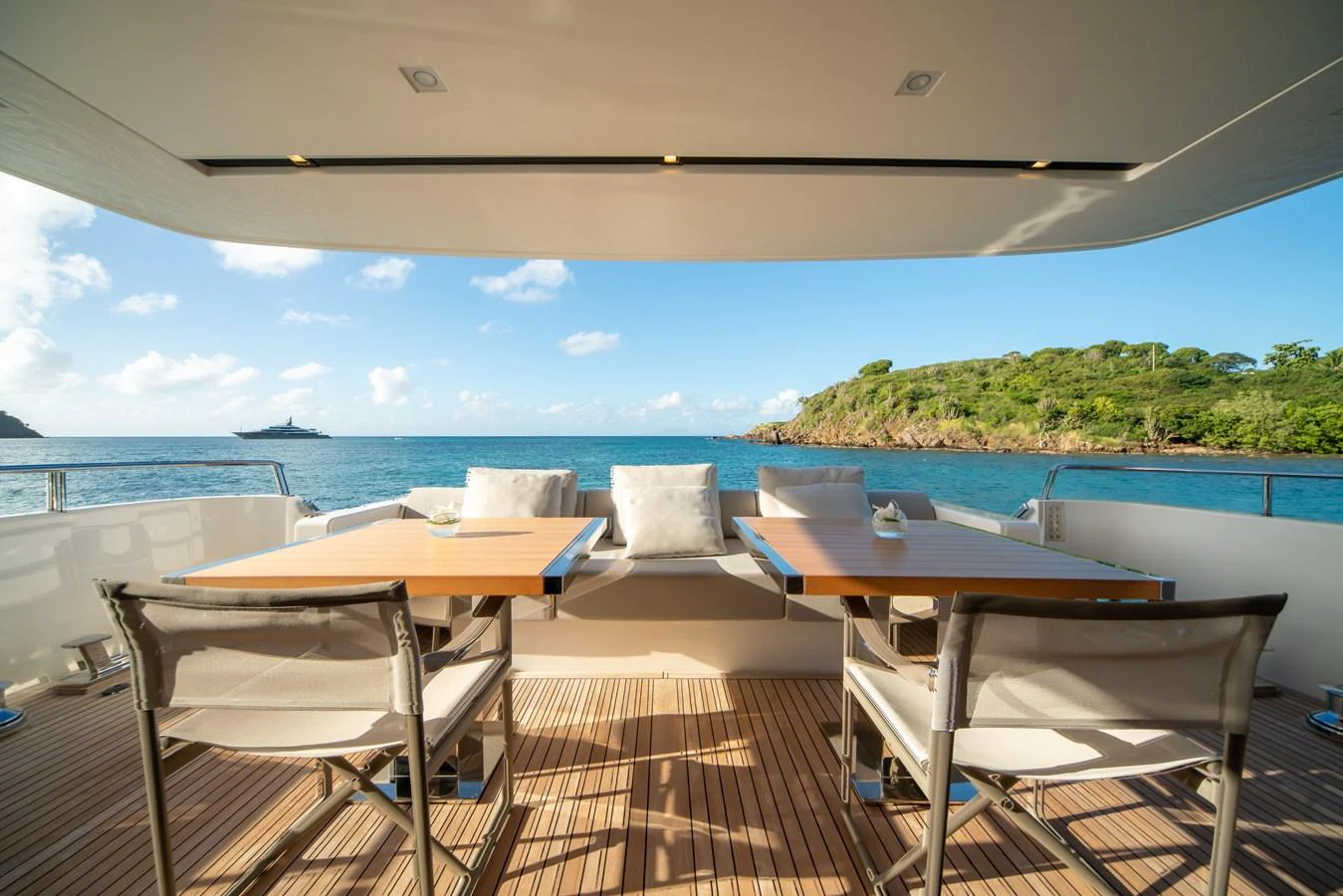 The aft deck offers a serene dining area with stunning ocean views. aboard AKULA Yacht for Sale