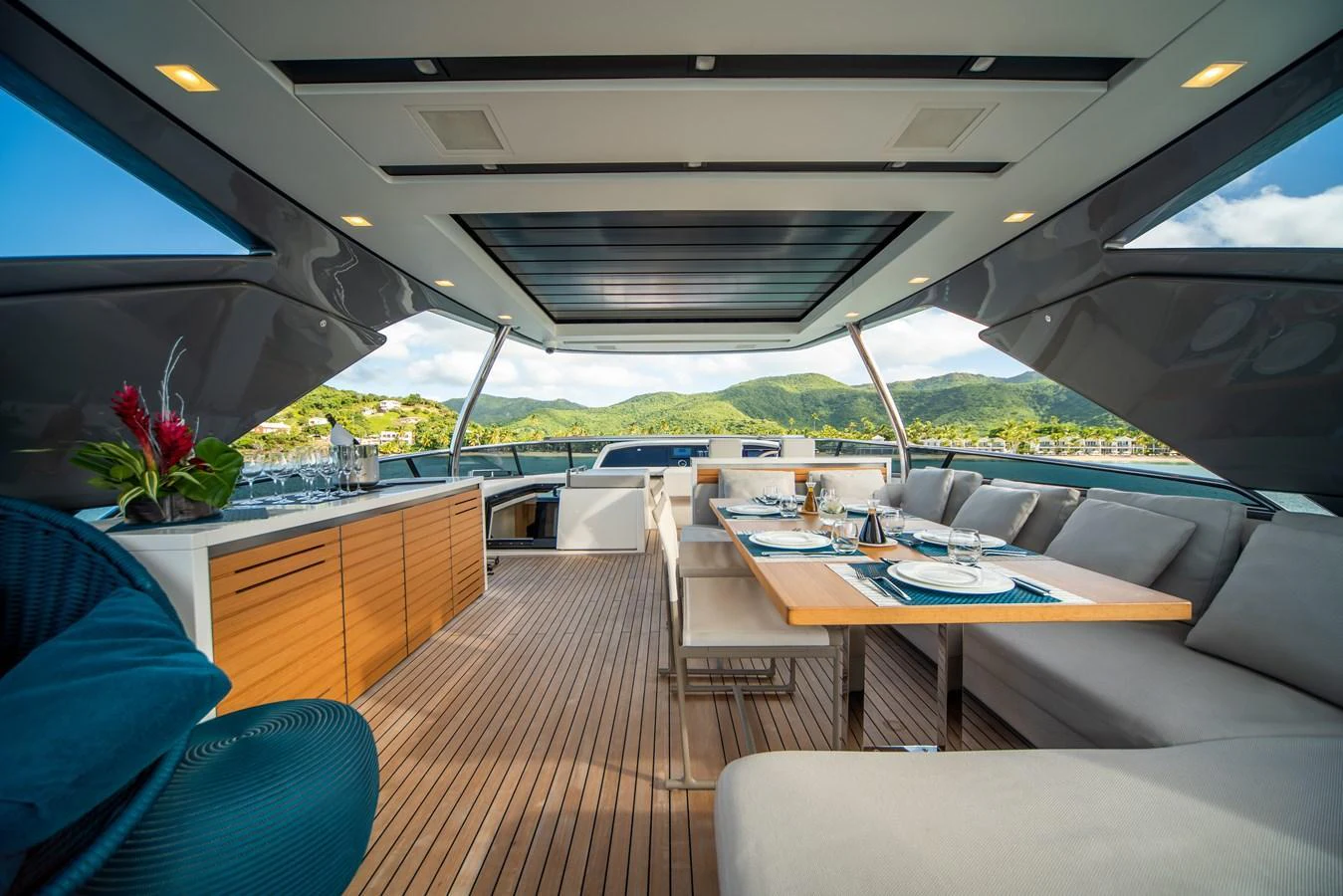 The aft deck features a stylish dining area with panoramic views. aboard AKULA Yacht for Sale