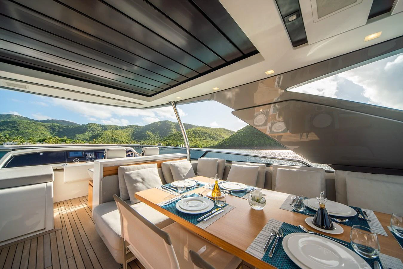 The yacht features an elegant dining area with a scenic view of the surrounding landscape. aboard AKULA Yacht for Sale