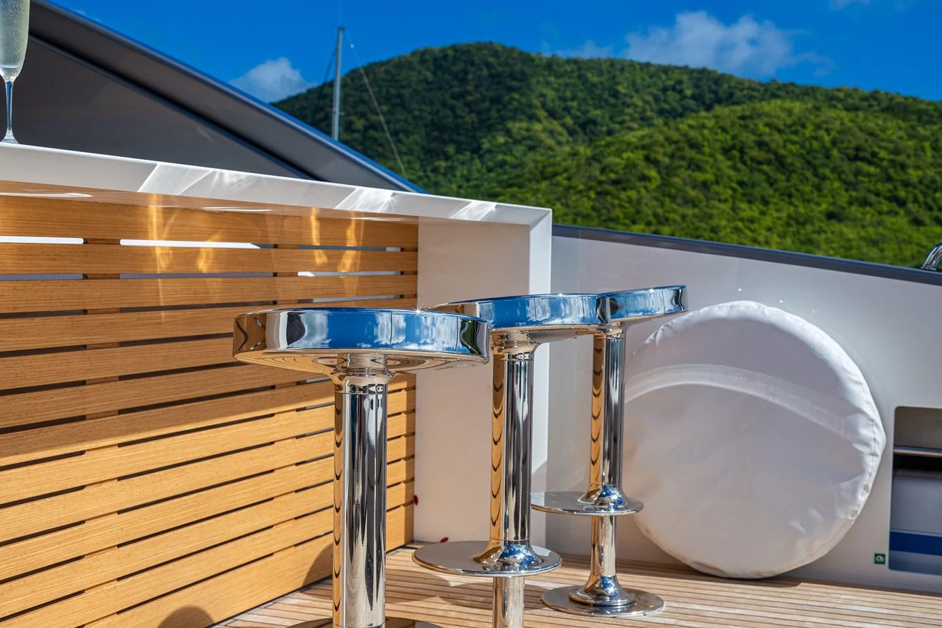 A stylish bar area on the yacht with sleek bar stools and a beautiful natural backdrop. aboard AKULA Yacht for Sale
