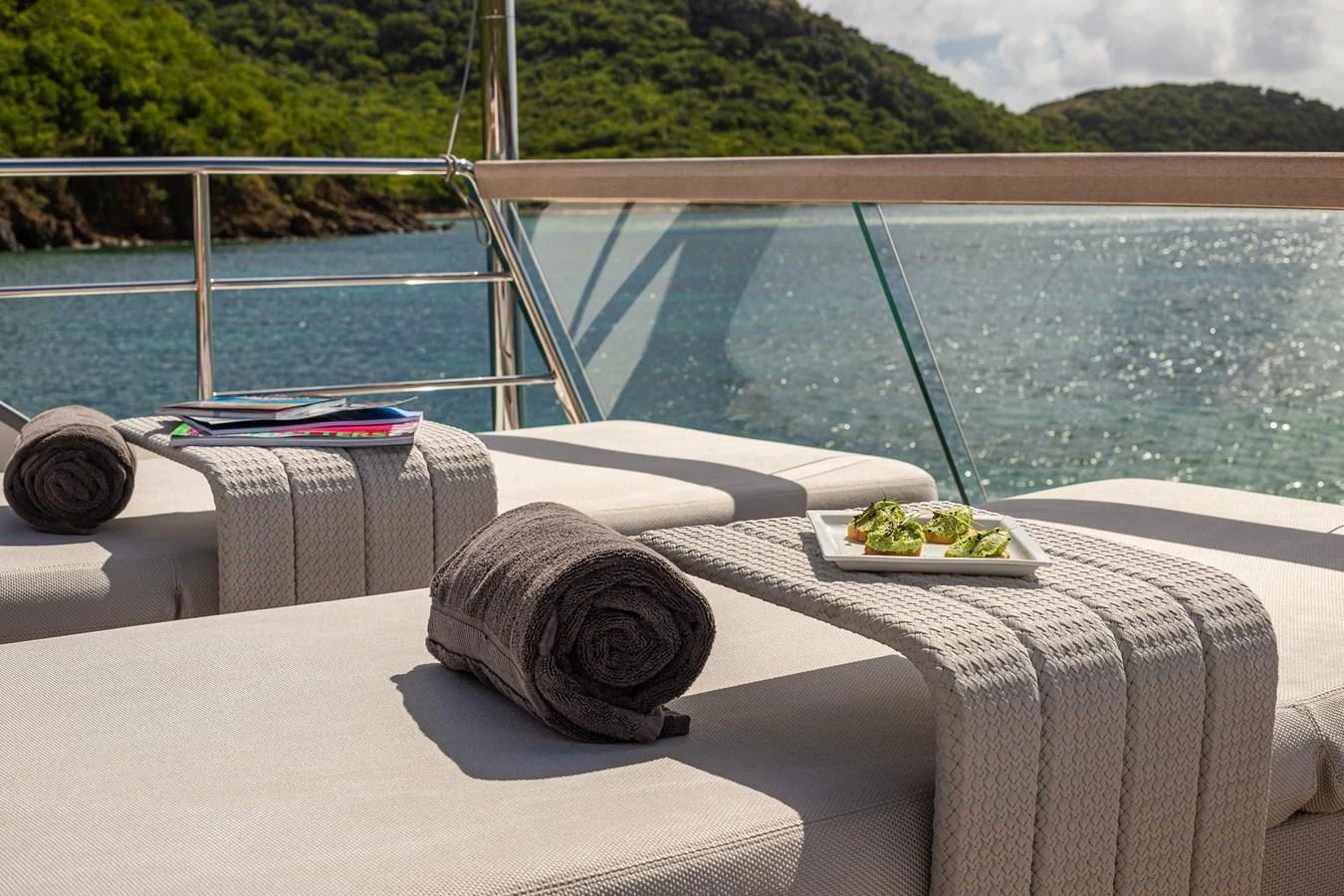 The sundeck offers a serene spot for relaxation with plush loungers and a scenic view of the water. aboard AKULA Yacht for Sale