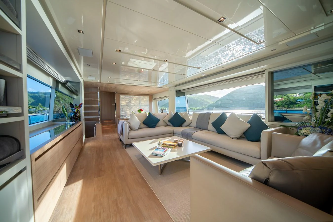 The salon features a spacious and elegant seating area with large windows offering panoramic views. aboard AKULA Yacht for Sale