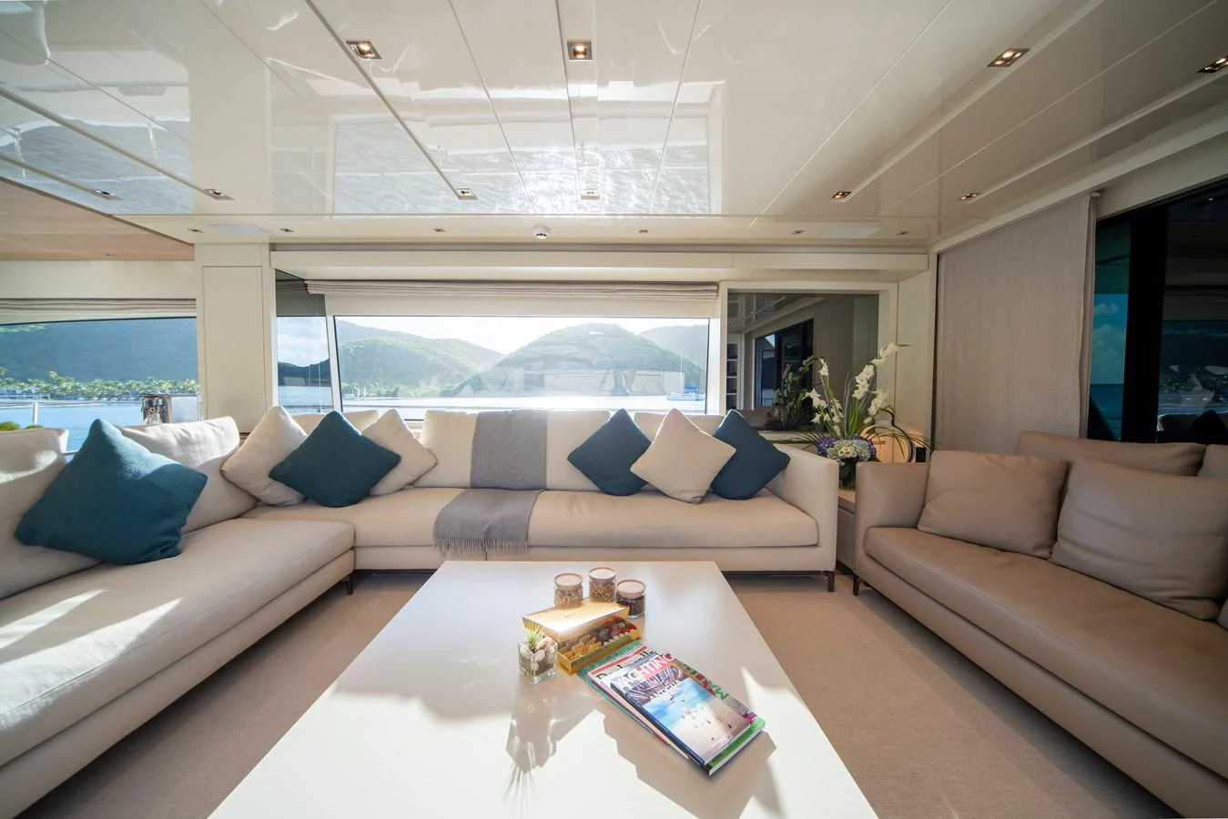 The salon offers a spacious and comfortable seating area with large windows providing stunning views. aboard AKULA Yacht for Sale