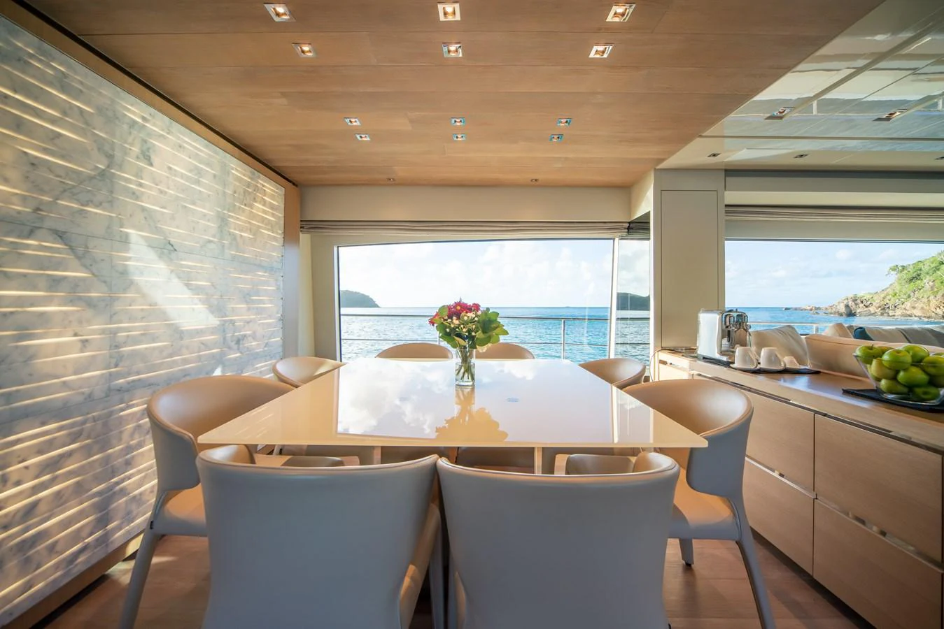 The yacht's dining area offers a serene and elegant setting with panoramic ocean views. aboard AKULA Yacht for Sale