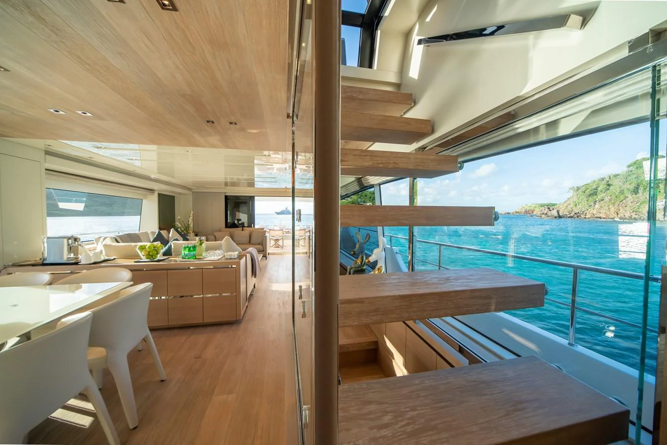 The salon features modern furnishings and large windows offering stunning ocean views. aboard AKULA Yacht for Sale