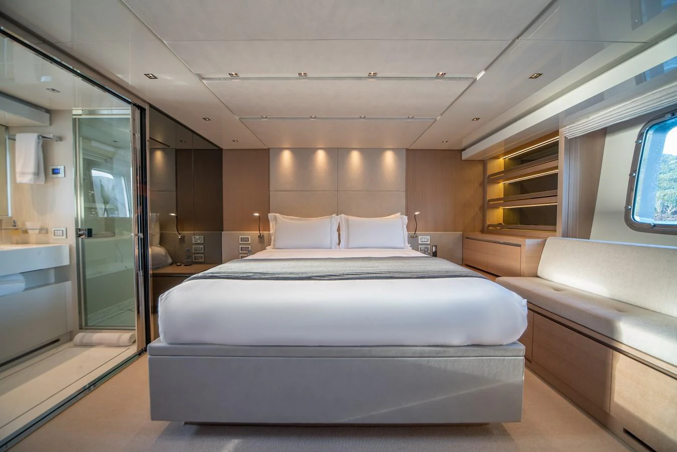 The master stateroom features a spacious bed with modern, elegant decor and ample natural light. aboard AKULA Yacht for Sale