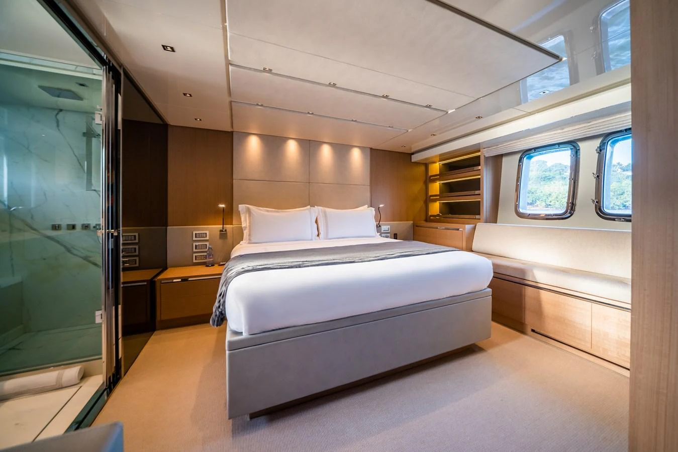 The master stateroom features a luxurious bed with ample natural light and elegant furnishings. aboard AKULA Yacht for Sale