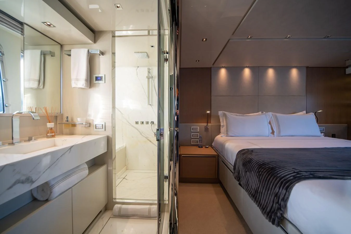The master stateroom features a luxurious bed and an en-suite bathroom with modern amenities. aboard AKULA Yacht for Sale