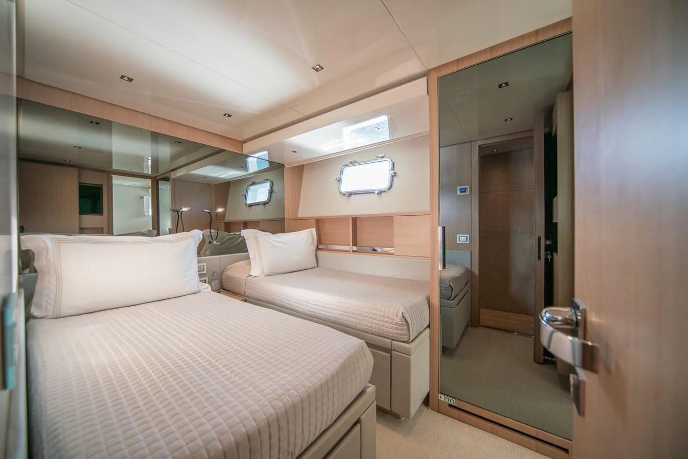The guest stateroom features twin beds with a modern and cozy design. aboard AKULA Yacht for Sale