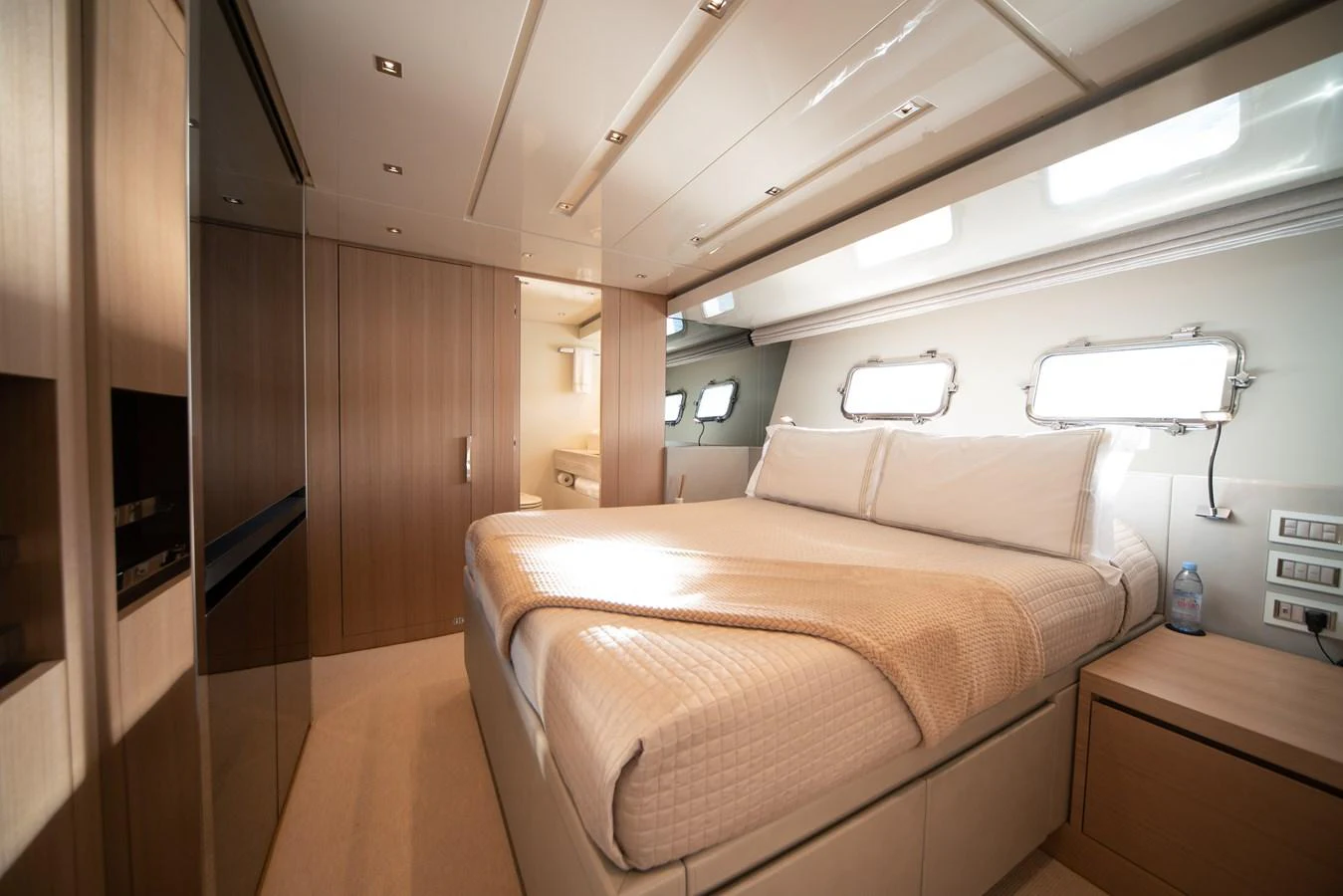 The stateroom features a plush bed with ample natural light from the windows, creating a serene and inviting atmosphere. aboard AKULA Yacht for Sale