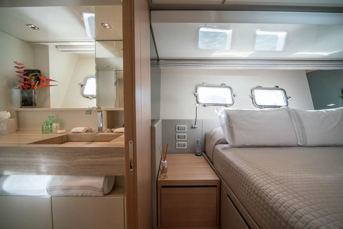 A cozy stateroom featuring a comfortable bed and a well-appointed vanity area. aboard AKULA Yacht for Sale
