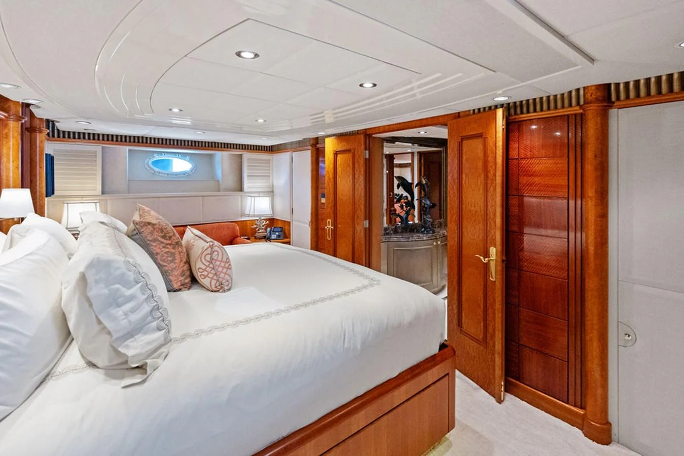 a bedroom with a bed and a mirror aboard PICOSA LADY Yacht for Sale