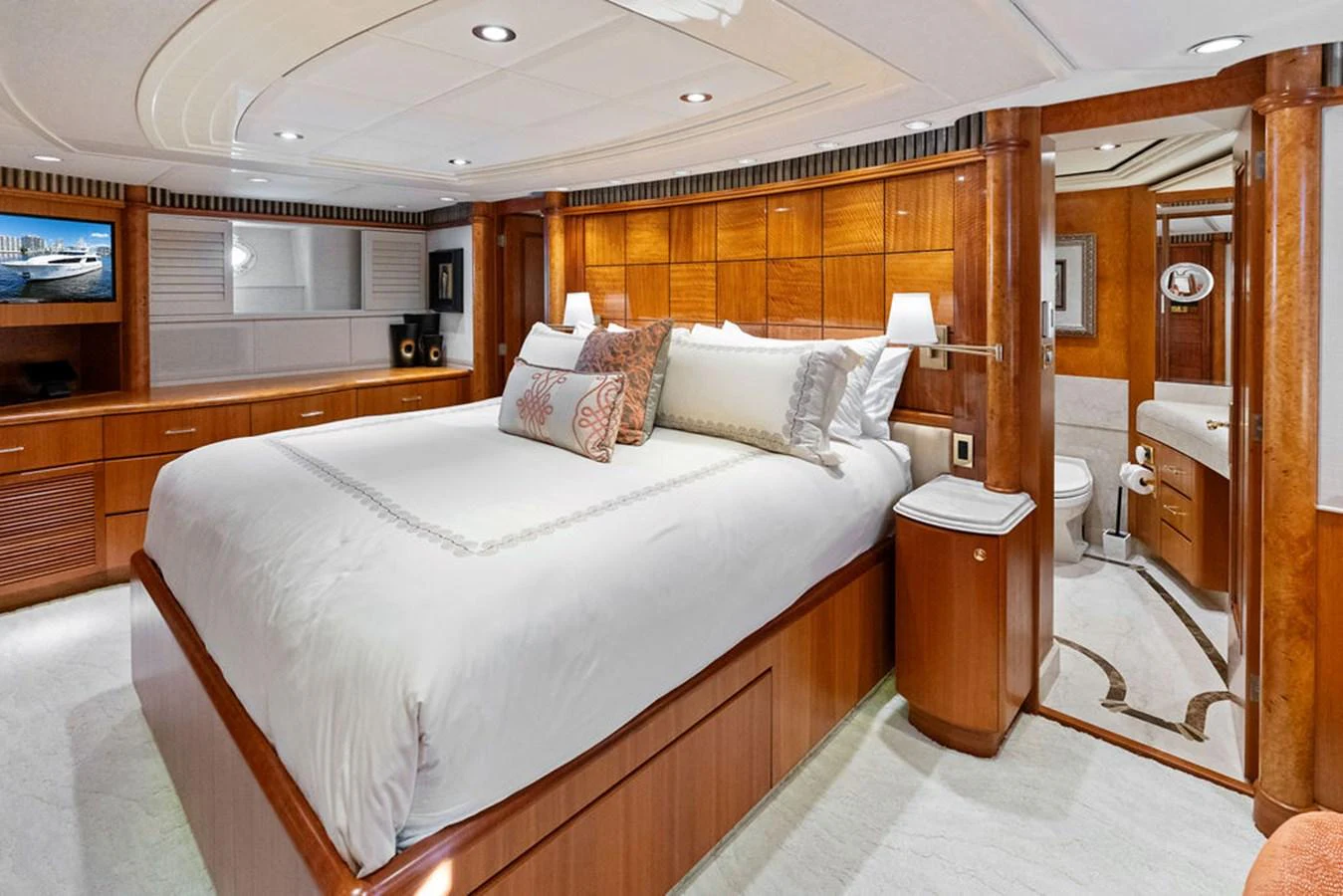 a bedroom with a bed and a mirror aboard PICOSA LADY Yacht for Sale