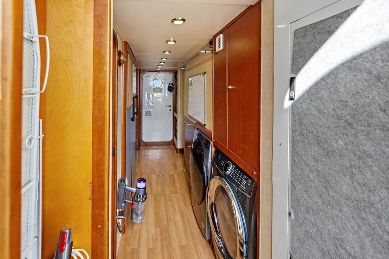 a hallway with a door and a bicycle aboard PICOSA LADY Yacht for Sale