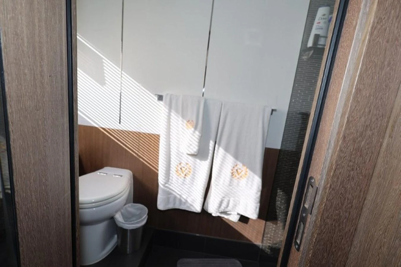 a bathroom with a toilet and towels aboard GLN65001J819 Yacht for Sale