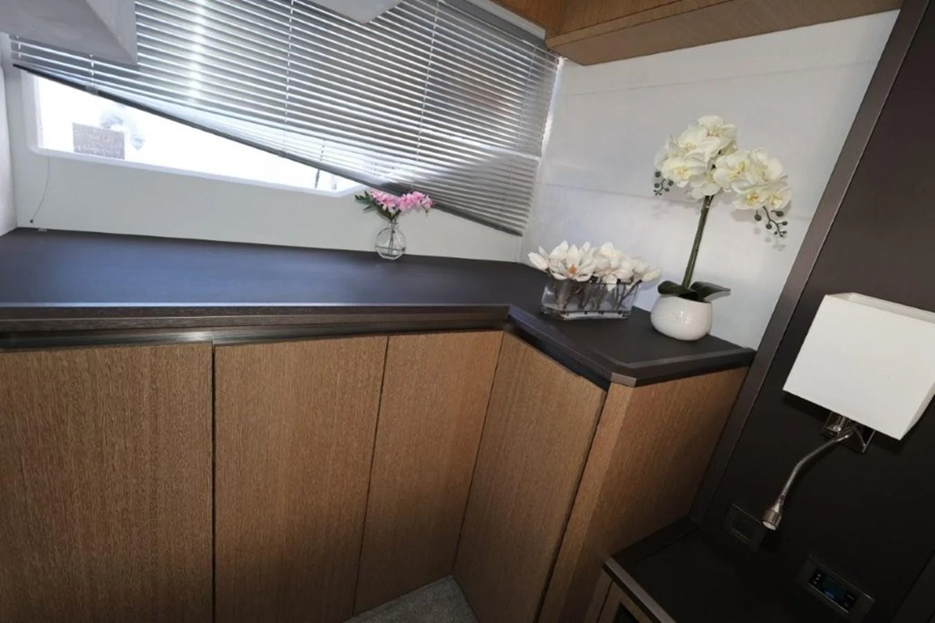 a desk with a lamp and flowers aboard GLN65001J819 Yacht for Sale