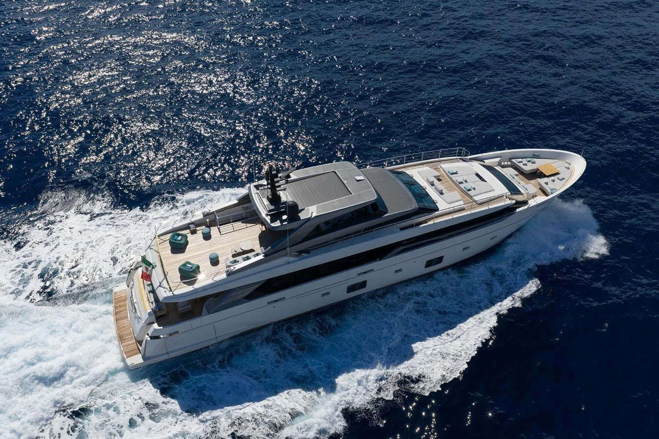 A sleek and modern yacht cruises through the open sea, showcasing its elegant design and spacious deck areas. aboard LADY LU' Yacht for Sale
