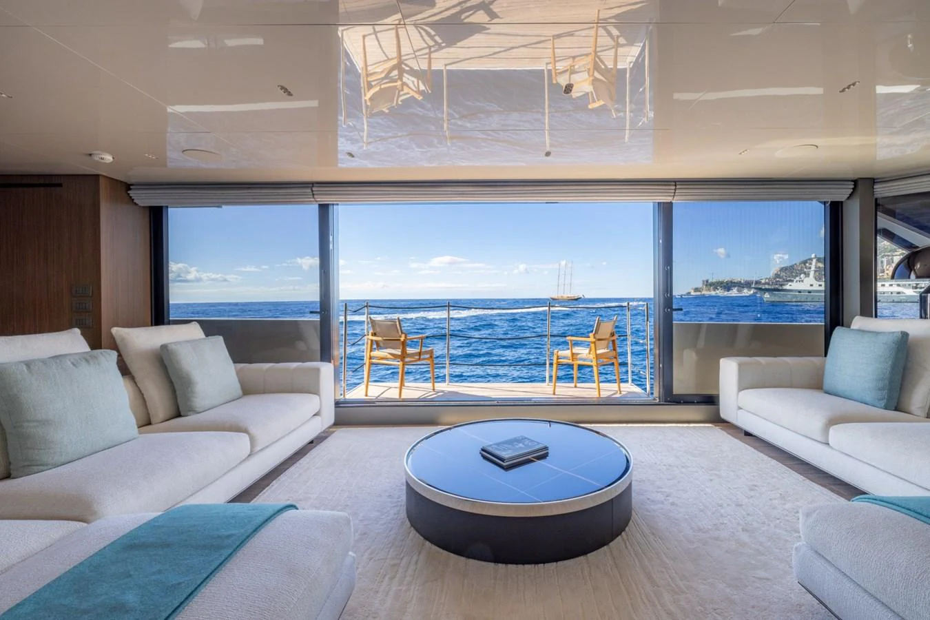 The salon offers a spacious and luxurious seating area with a stunning ocean view through large windows. aboard LADY LU' Yacht for Sale