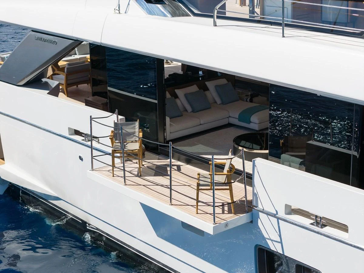 The yacht features a stylish side deck with comfortable seating and large windows offering a glimpse into the luxurious interior. aboard LADY LU' Yacht for Sale