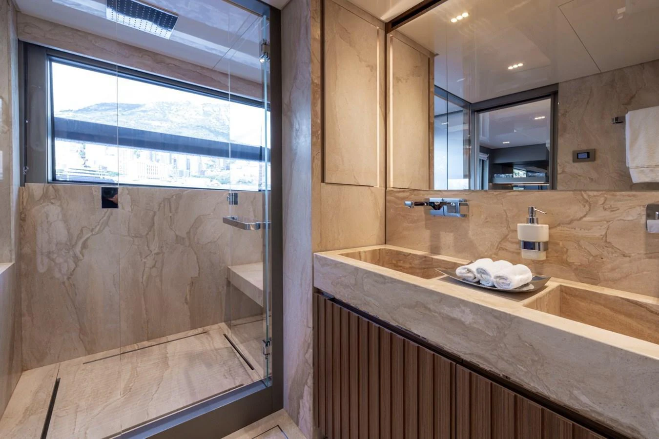 The yacht's bathroom features a luxurious design with a spacious shower and elegant fixtures. aboard LADY LU' Yacht for Sale