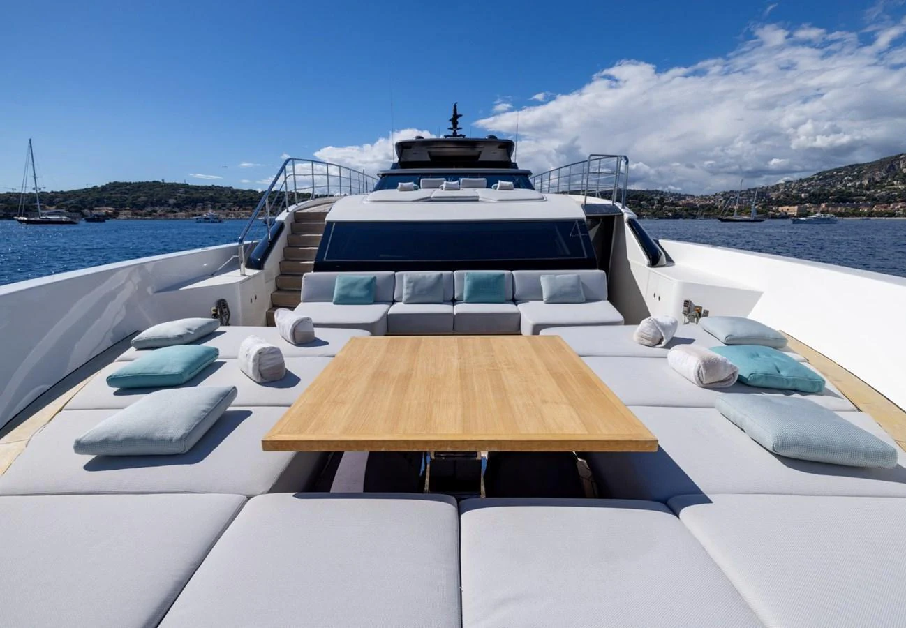 The foredeck features a spacious sunbathing area with plush cushions and a central table, perfect for relaxation and socializing. aboard LADY LU' Yacht for Sale