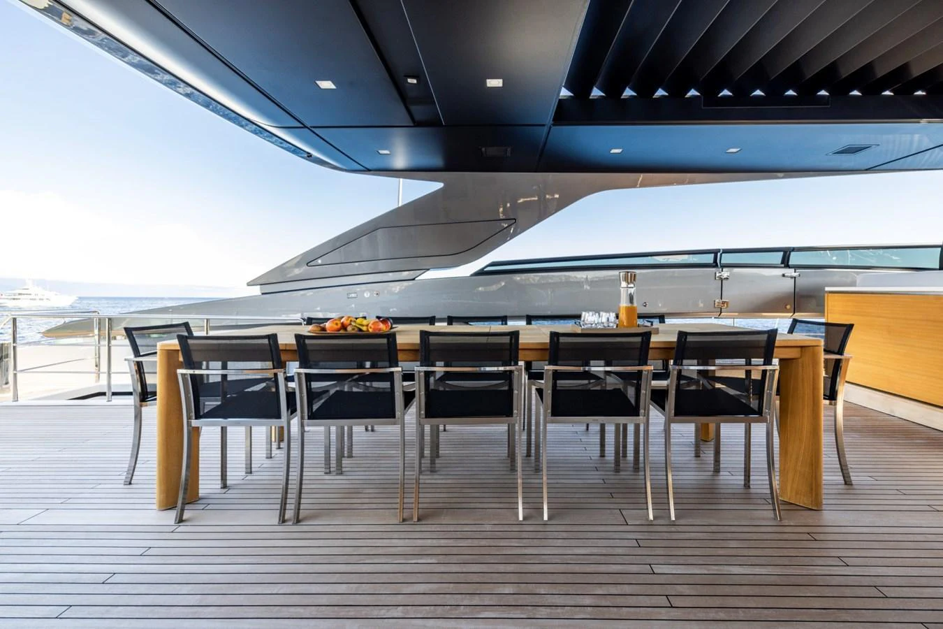 The aft deck features a spacious dining area with a sleek, modern design and stunning ocean views. aboard LADY LU' Yacht for Sale