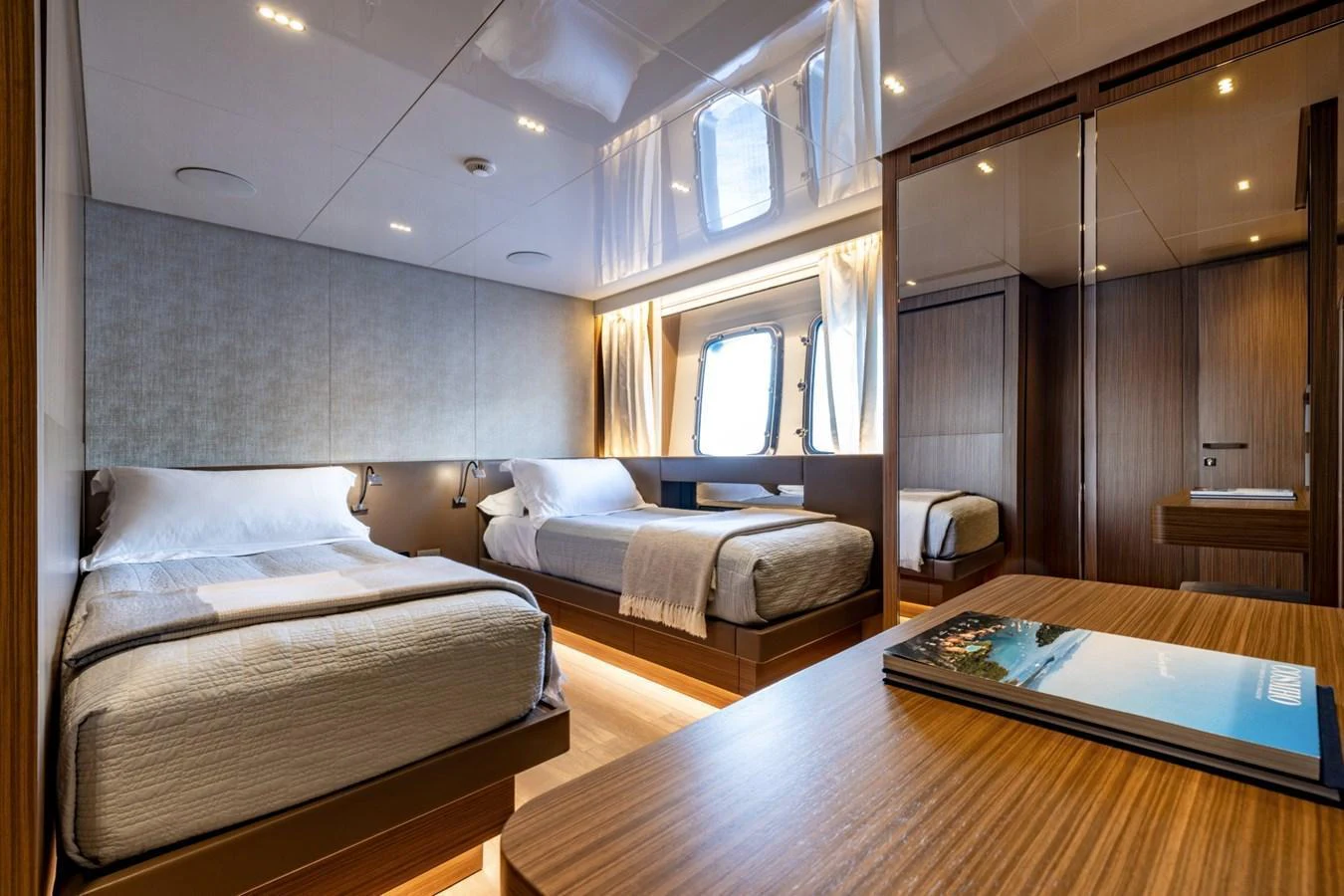 The guest stateroom features twin beds, warm wood finishes, and ample natural light. aboard LADY LU' Yacht for Sale
