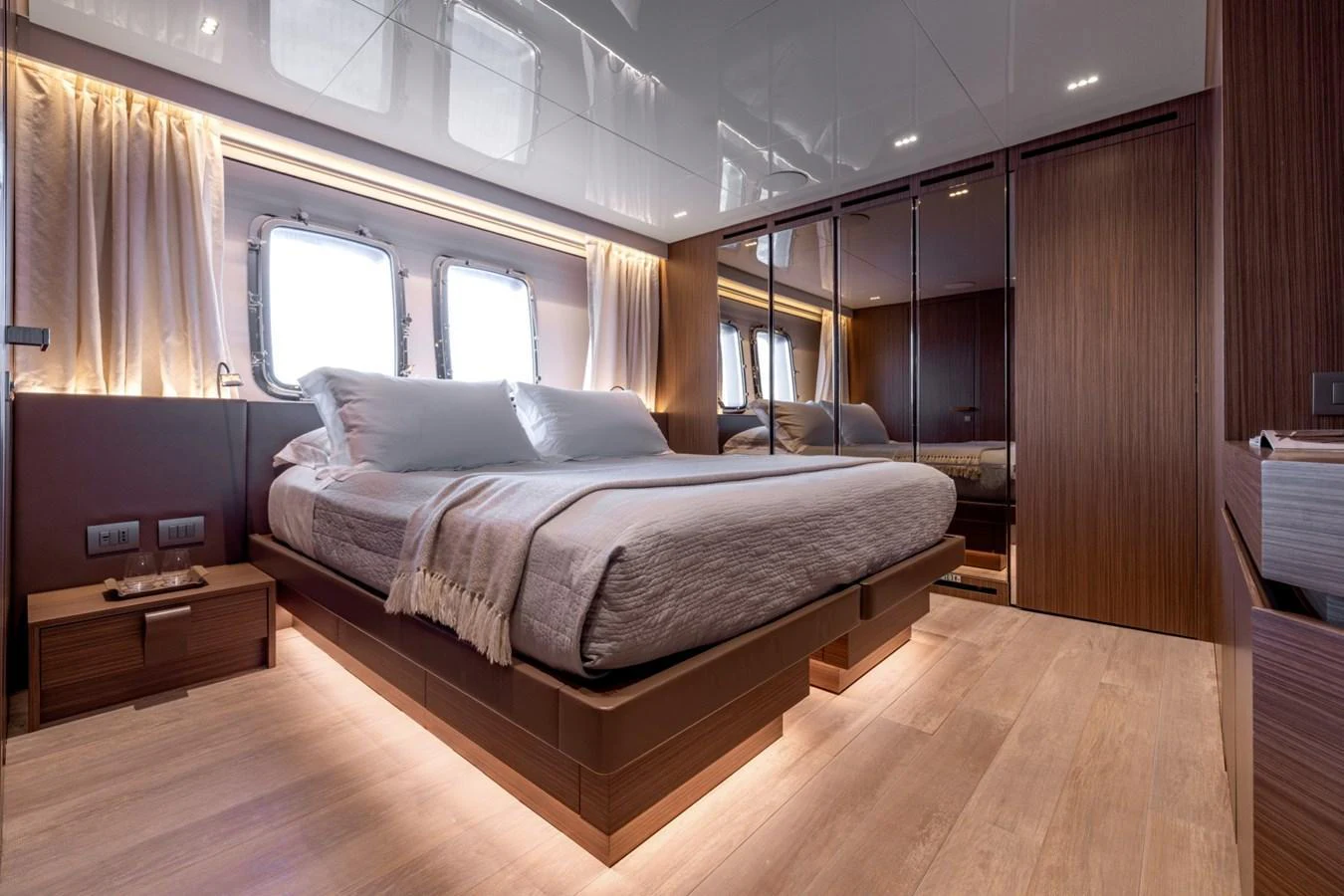 A luxurious stateroom featuring a large bed, modern furnishings, and ample natural light. aboard LADY LU' Yacht for Sale