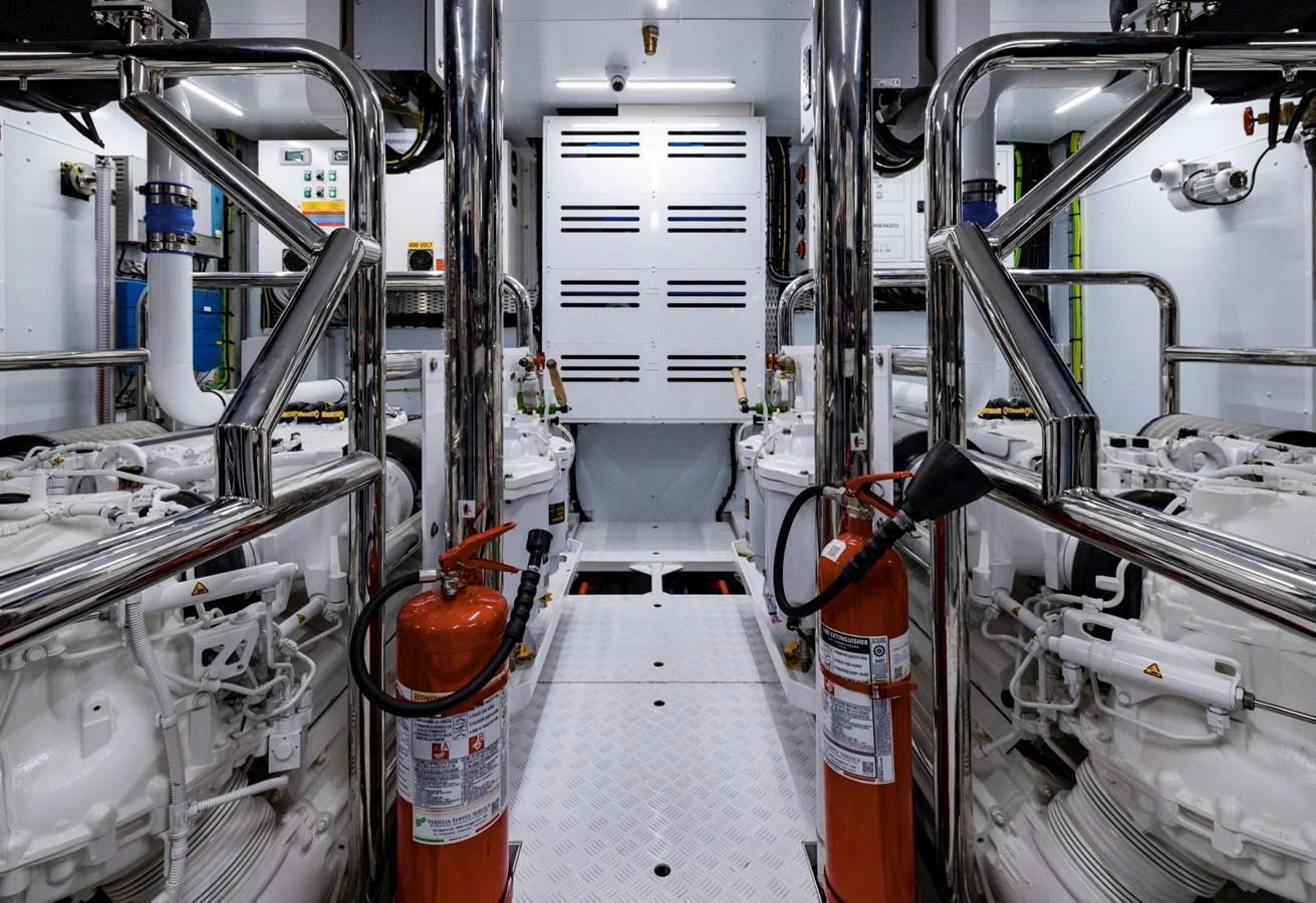 The engine room is meticulously organized with polished metal surfaces and essential safety equipment. aboard LADY LU' Yacht for Sale