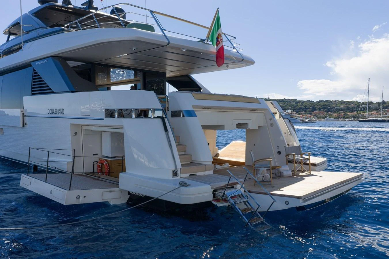 The yacht's aft deck features a spacious lounging area with direct access to the water, perfect for relaxation and entertainment. aboard LADY LU' Yacht for Sale