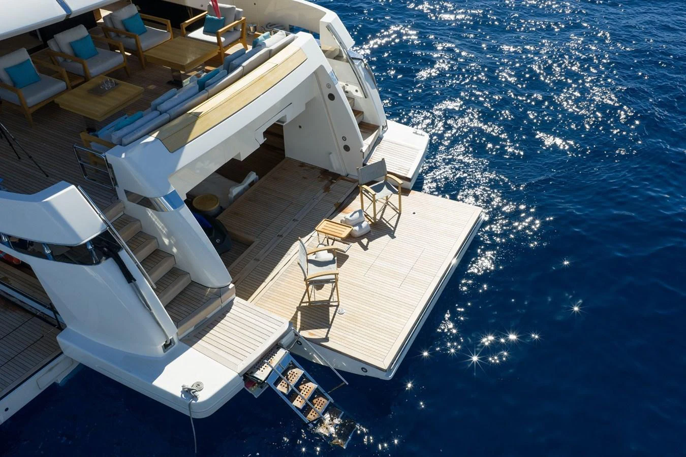 The yacht's aft deck features a spacious lounging area with direct access to the water. aboard LADY LU' Yacht for Sale