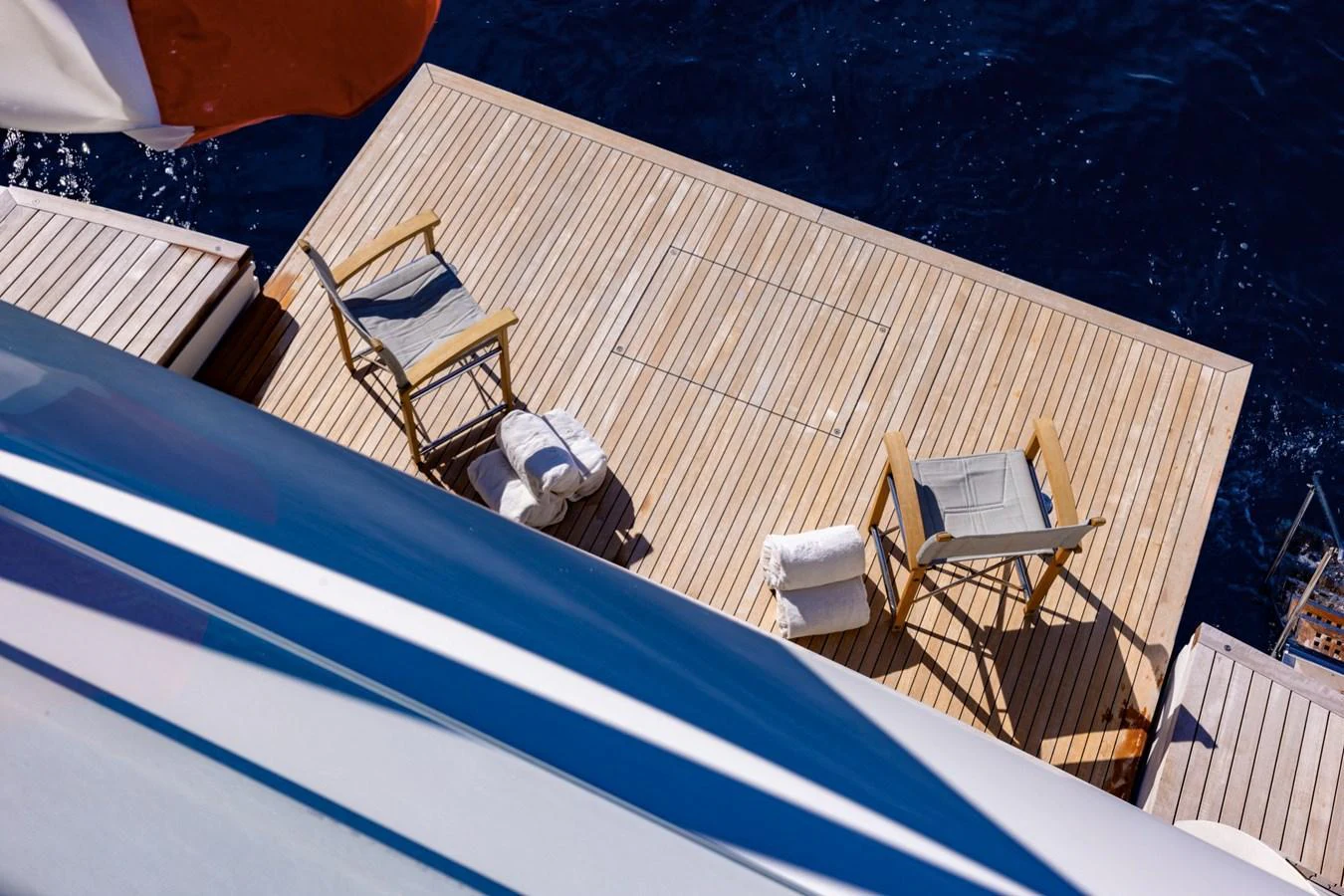 The yacht features a spacious swim platform with comfortable seating and direct access to the water. aboard LADY LU' Yacht for Sale
