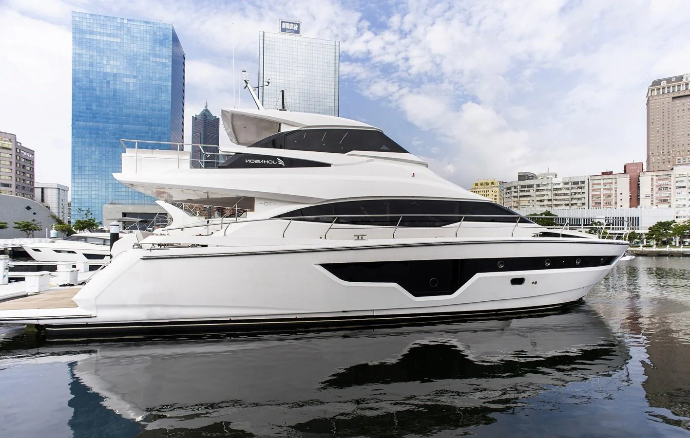 a white yacht in a harbor aboard 70' JOHNSON SKYLOUNGE 2026 Yacht for Sale
