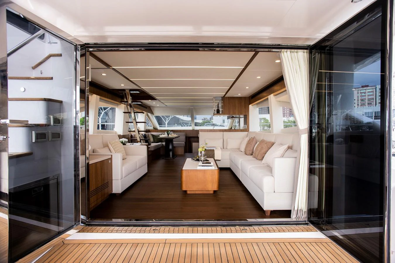 a living room with a large window aboard 70' JOHNSON SKYLOUNGE 2026 Yacht for Sale